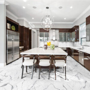 Mayfair Statuario Venato porcelain tile in kitchen with brown cabinets